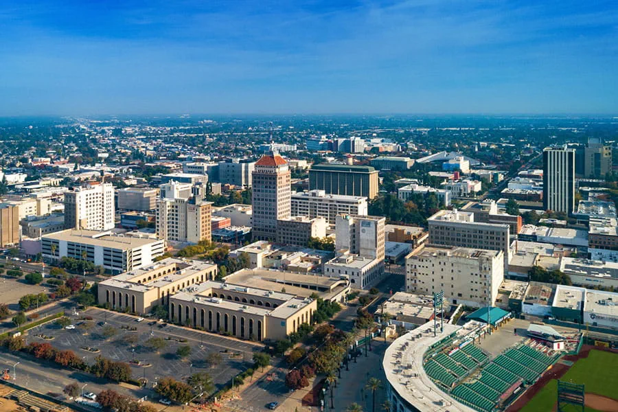 An aerial view of the city of Fresno, CA during a bright and sunny day
