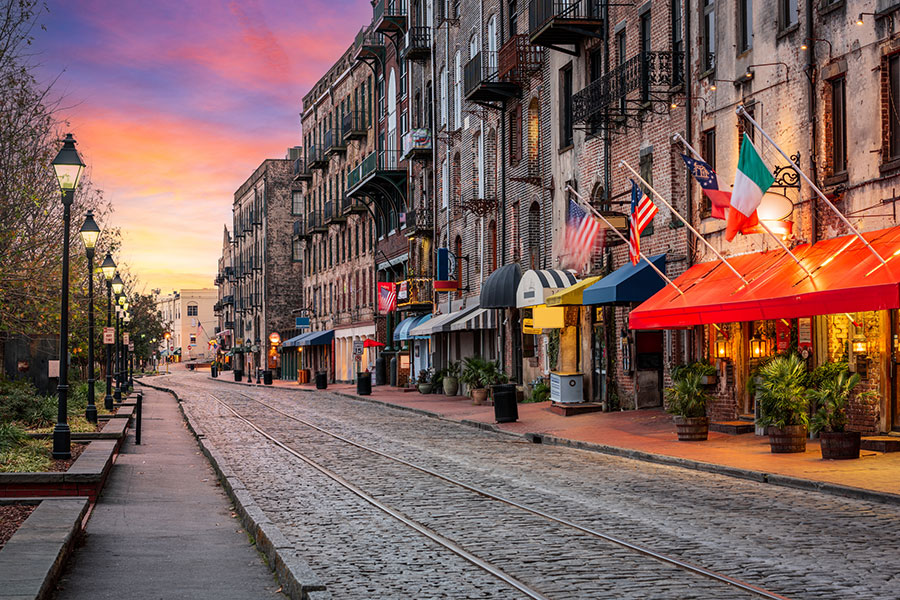 A view down a deserted River Street in Savannah, GA at dawn before any businesses have opened