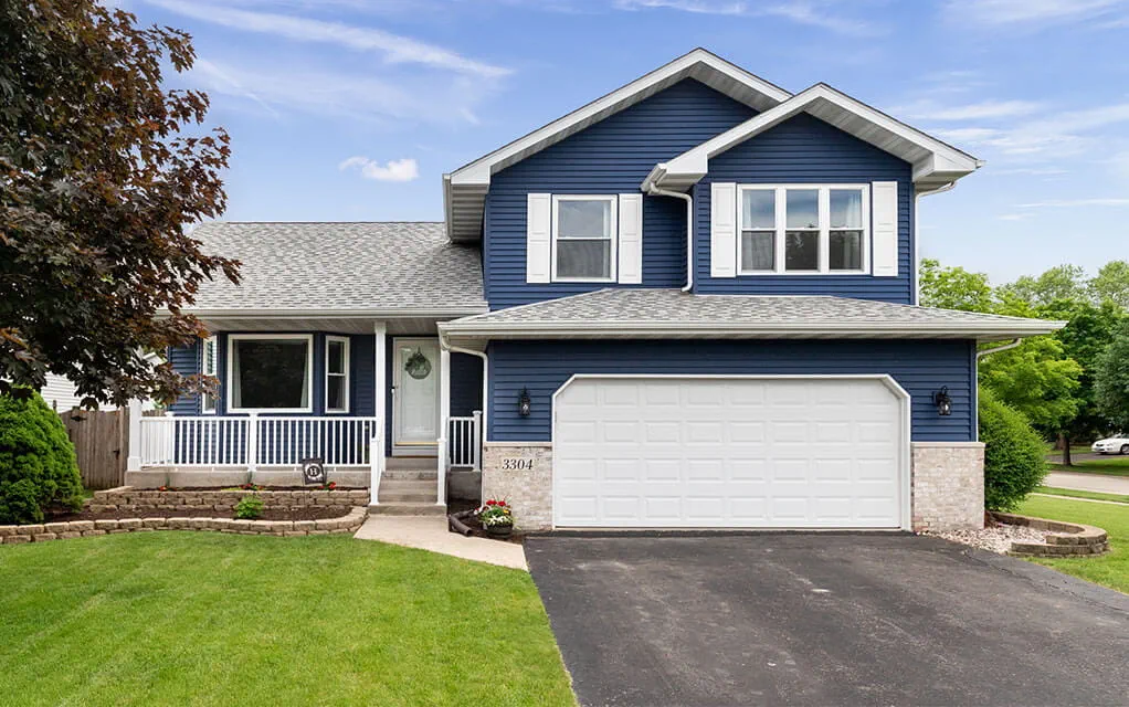 View of the front of a suburban middle class two story home with it's garage prominently featured