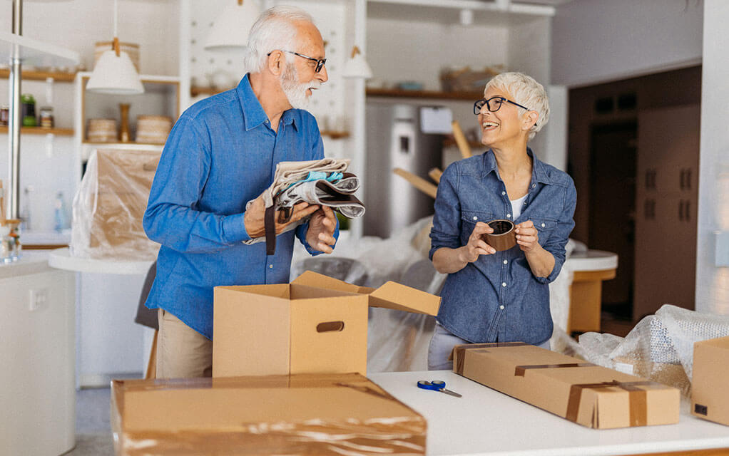 A retired couple is unpacking in their new home after making a move