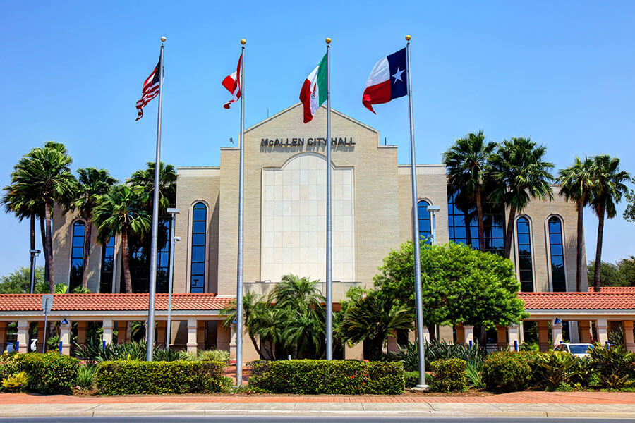 A view of the McAllen, TX city hall on a bright and sunny day