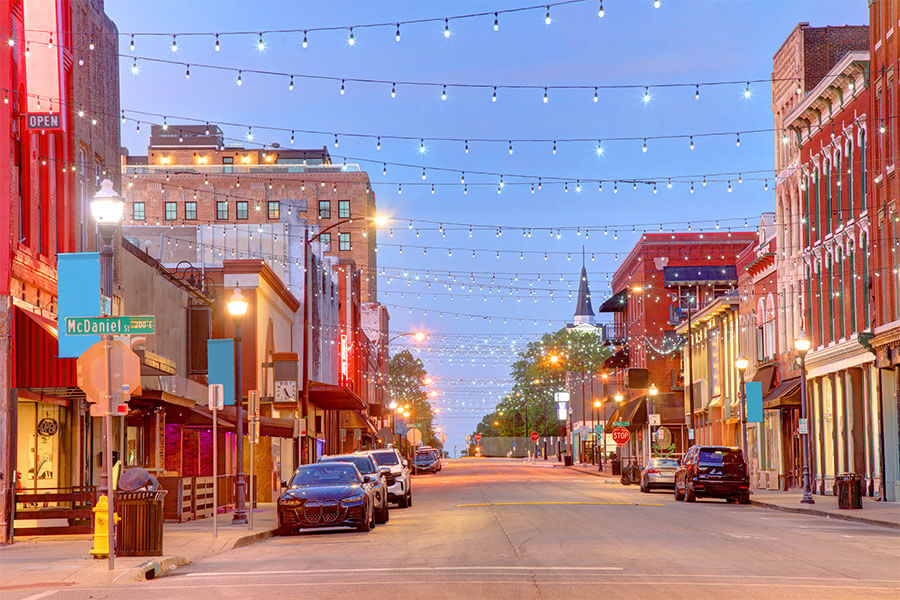 A view down a main street in Springfield, MO as the sun sets on a clear evening